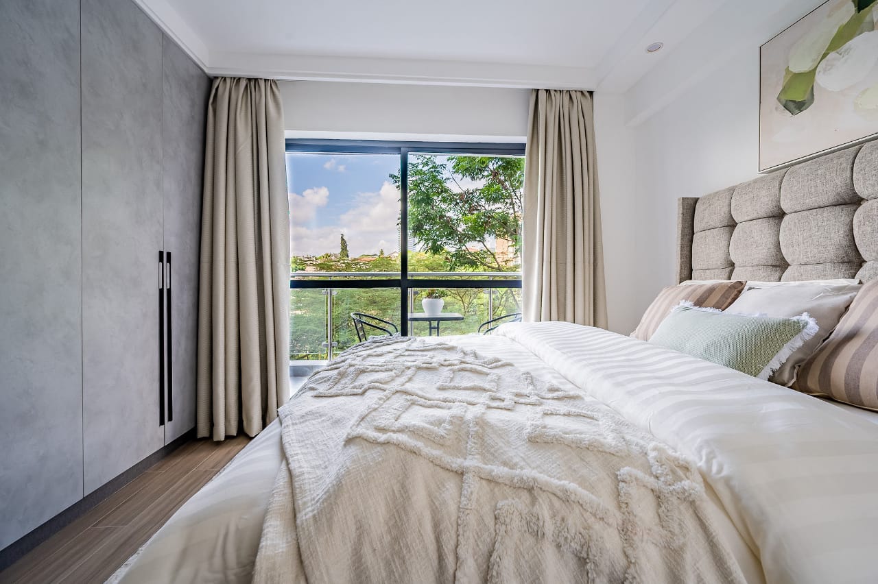 Ensuite bedroom with large window in Riverside Nairobi apartment